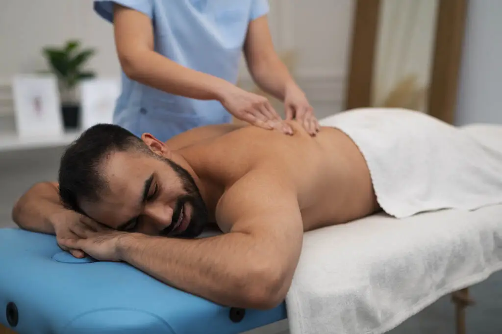 Therapist giving backpain massage